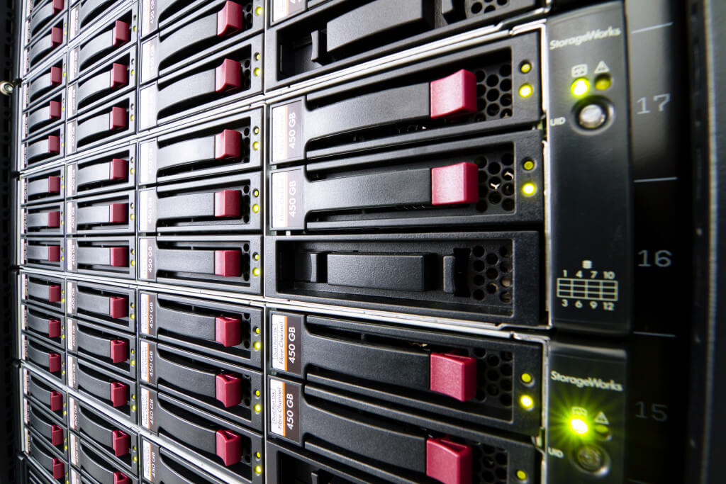 Row of hard drives mounted in a rack in a data center